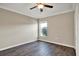 Comfortable bedroom with modern ceiling fan and a window bringing in natural light at 11309 Langworth Hill Ln, Riverview, FL 33579