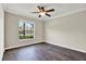 Neutral bedroom with a window and wood floors complemented by natural light at 11309 Langworth Hill Ln, Riverview, FL 33579