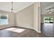 Bright dining room with wood-look floors, chandelier, and sliding glass doors that lead to a outdoor space at 11309 Langworth Hill Ln, Riverview, FL 33579