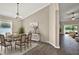 Dining room features hardwood floors, a dining table with seating for six, and a chandelier light fixture at 11309 Langworth Hill Ln, Riverview, FL 33579