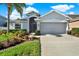 Charming single-story home with lush landscaping and a two-car garage in a well-maintained community at 11309 Langworth Hill Ln, Riverview, FL 33579