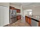 Modern kitchen features stainless steel appliances, granite countertops, rich wood cabinets, and stylish flooring at 11309 Langworth Hill Ln, Riverview, FL 33579