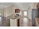 Modern kitchen featuring granite countertops, stainless steel appliances, and wood flooring at 11309 Langworth Hill Ln, Riverview, FL 33579