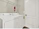 Functional laundry room equipped with a washer, dryer, and white door at 11309 Langworth Hill Ln, Riverview, FL 33579