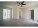 Spacious bedroom features a ceiling fan, sliding glass doors, and ensuite bathroom access at 11403 Wellman Dr, Riverview, FL 33578