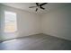 Bright bedroom features a ceiling fan, wood-look floors, and a window at 11403 Wellman Dr, Riverview, FL 33578