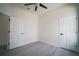 Nicely sized bedroom with a ceiling fan, neutral paint, and wood look floors at 11403 Wellman Dr, Riverview, FL 33578