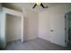 Neutrally painted room showcasing an open closet, ceiling fan, and wood look floors at 11403 Wellman Dr, Riverview, FL 33578