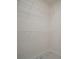 Walk-in closet features shelving with white walls and granite-look tile at 11403 Wellman Dr, Riverview, FL 33578