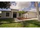 Charming single-story home featuring a well-maintained lawn and inviting curb appeal with decorative landscaping at 11403 Wellman Dr, Riverview, FL 33578