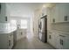 Updated kitchen featuring modern appliances, white cabinetry, granite countertops, and ample natural light at 11403 Wellman Dr, Riverview, FL 33578