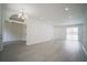 Open-concept living space with gray flooring, recessed lighting, and seamless flow to other areas of the house at 11403 Wellman Dr, Riverview, FL 33578
