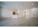 Spacious living room featuring sleek gray flooring and abundant natural light, leading into the kitchen at 11403 Wellman Dr, Riverview, FL 33578