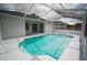 Beautiful backyard swimming pool with a screened enclosure and white concrete trim at 11403 Wellman Dr, Riverview, FL 33578