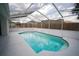 A screened-in pool with clear blue water is perfect for relaxing in the sun at 11403 Wellman Dr, Riverview, FL 33578