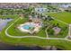 Aerial view of community pool and amenities, including pool, splashpad, and playground at 11714 Tetrafin Dr, Riverview, FL 33579