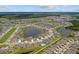 Aerial view of the neighborhood showcasing homes, ponds, and surrounding landscape at 11714 Tetrafin Dr, Riverview, FL 33579