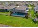 Aerial view of a home with a screened pool, fenced yard, landscaping, and a great view of the neighborhood at 11714 Tetrafin Dr, Riverview, FL 33579