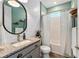 Charming bathroom with granite vanity, white shiplap, updated fixtures, and wood-look tile flooring at 11714 Tetrafin Dr, Riverview, FL 33579