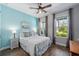 Beautiful bedroom featuring a ceiling fan, modern wood floors, and stylish nautical decor at 11714 Tetrafin Dr, Riverview, FL 33579