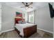 Comfortable bedroom with a wooden bed frame, modern decor, and a ceiling fan at 11714 Tetrafin Dr, Riverview, FL 33579