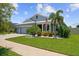 Well-maintained home boasting a neatly manicured lawn and tropical landscaping at 11714 Tetrafin Dr, Riverview, FL 33579