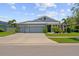 Beautiful home with a three-car garage, lush landscaping, and inviting curb appeal at 11714 Tetrafin Dr, Riverview, FL 33579