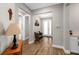 Hallway with a wooden bench and modern tile flooring leading to the front door at 11714 Tetrafin Dr, Riverview, FL 33579