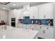 Well-equipped kitchen with a range, white cabinetry, a subway tile backsplash, and stone countertops at 11714 Tetrafin Dr, Riverview, FL 33579