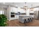 Bright kitchen with white cabinets, stainless steel appliances, a wooden-style island, and modern pendant lights at 11714 Tetrafin Dr, Riverview, FL 33579