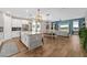 Beautiful open-concept kitchen with an island, pendant lighting, and tile flooring that extends into the living area at 11714 Tetrafin Dr, Riverview, FL 33579