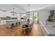 Open-concept kitchen with an island, pendant lights, wood floors, and a seamless transition to the dining area at 11714 Tetrafin Dr, Riverview, FL 33579