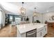 Open-concept kitchen with stainless steel appliances, a center island, and a seamless flow into the living area at 11714 Tetrafin Dr, Riverview, FL 33579
