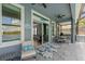 Covered lanai offers dining and lounge spaces with views of the pool and lake at 11714 Tetrafin Dr, Riverview, FL 33579
