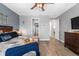 Bright main bedroom with neutral walls, a king bed, and views into the bathroom and bedroom doors at 11714 Tetrafin Dr, Riverview, FL 33579