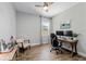 Home office with dual monitors, a comfortable chair, and wood-look tile at 11714 Tetrafin Dr, Riverview, FL 33579