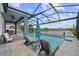 Relaxing screened-in pool area with comfortable seating, a picturesque lake view, and a calming atmosphere at 11714 Tetrafin Dr, Riverview, FL 33579
