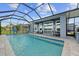 An expansive private pool area with covered seating and panoramic views of the lake at 11714 Tetrafin Dr, Riverview, FL 33579