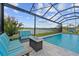 Stunning screened-in pool area with comfortable seating and scenic lake views at 11714 Tetrafin Dr, Riverview, FL 33579