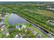 Aerial view showcases a lakeside home with lush landscaping, serene water views, and community surroundings at 12439 Bristol Commons Cir, Tampa, FL 33626
