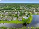 Aerial view of a charming neighborhood nestled by a serene lake, offering picturesque homes and tranquil living at 12439 Bristol Commons Cir, Tampa, FL 33626