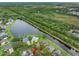 Aerial view showcases a lakeside home with lush landscaping, serene water views, and community surroundings at 12439 Bristol Commons Cir, Tampa, FL 33626