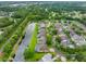 Expansive aerial view of a neighborhood with lush green spaces, serene ponds, and well-kept properties at 12439 Bristol Commons Cir, Tampa, FL 33626