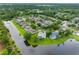 Aerial view of a neighborhood, many homes with pools, backing onto a lake at 12439 Bristol Commons Cir, Tampa, FL 33626
