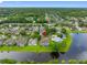 Aerial view of a charming neighborhood nestled by a serene lake, offering picturesque homes and tranquil living at 12439 Bristol Commons Cir, Tampa, FL 33626