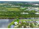 Aerial view captures lakefront homes nestled by lush greenery and tranquil lake; serene living at its finest at 12439 Bristol Commons Cir, Tampa, FL 33626
