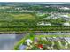 Aerial view captures lakefront homes nestled by lush greenery and tranquil lake; serene living at its finest at 12439 Bristol Commons Cir, Tampa, FL 33626