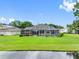 Backyard featuring a screened-in pool and verdant lawn, providing a private oasis with scenic views at 12439 Bristol Commons Cir, Tampa, FL 33626
