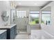 Bathroom featuring a glass shower, decorative sink, and unique patterned tile at 12439 Bristol Commons Cir, Tampa, FL 33626