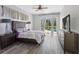 Bright bedroom featuring hardwood floors, ceiling fan, and large glass doors that lead to a pool area at 12439 Bristol Commons Cir, Tampa, FL 33626
